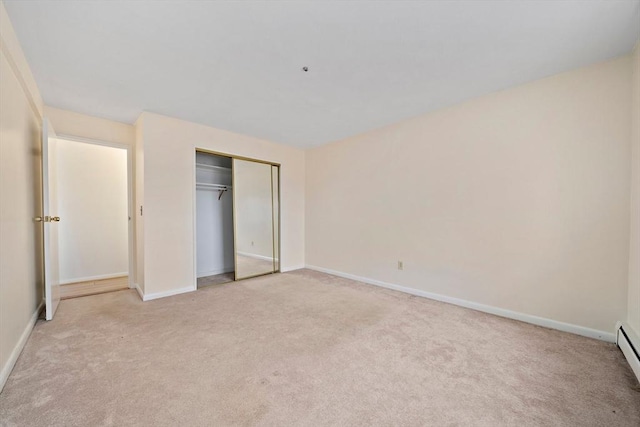 unfurnished bedroom featuring light colored carpet, a closet, and baseboards