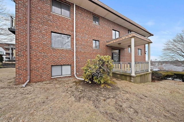 rear view of property featuring brick siding