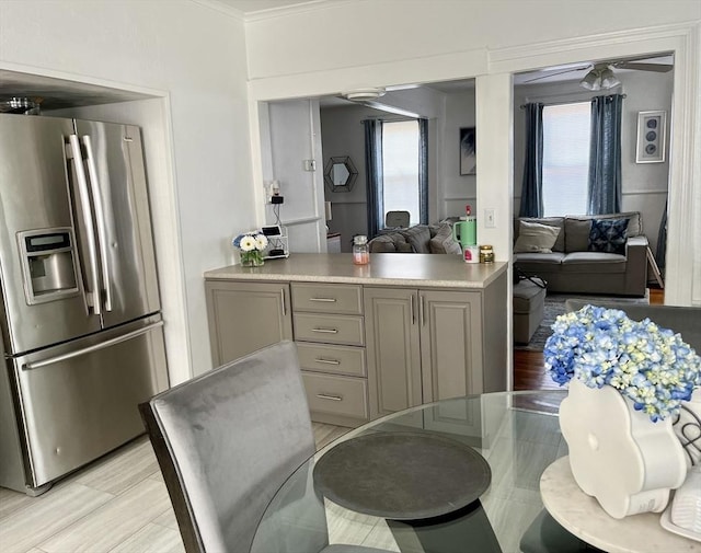 kitchen with gray cabinets and stainless steel fridge with ice dispenser