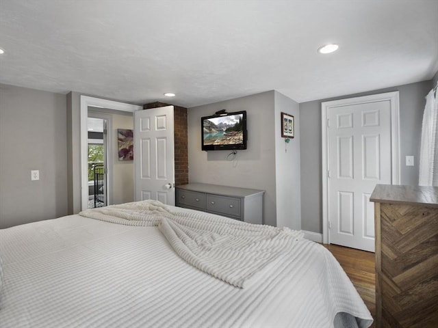 bedroom featuring recessed lighting, dark wood finished floors, and baseboards