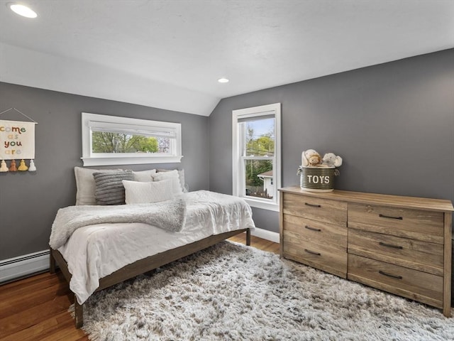 bedroom featuring recessed lighting, wood finished floors, vaulted ceiling, and baseboard heating
