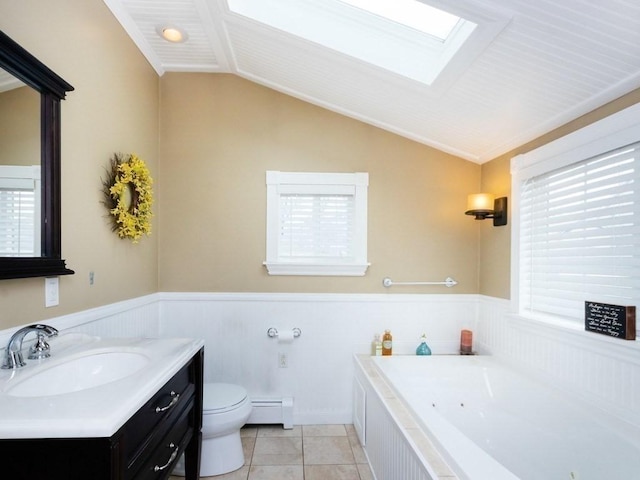 bathroom with vanity, toilet, a tub with jets, vaulted ceiling with skylight, and a baseboard radiator