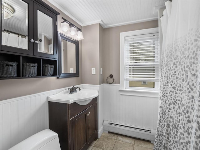 full bath with vanity, wainscoting, wooden walls, tile patterned floors, and a baseboard heating unit
