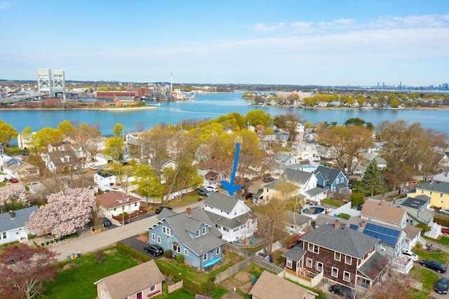 drone / aerial view with a residential view and a water view