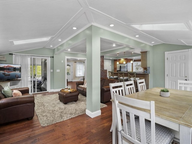 living room with wood finished floors, plenty of natural light, and lofted ceiling