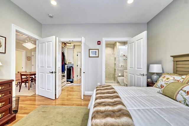 59 Walpole St Unit 202, Canton, MA 02021 - bedroom featuring light wood-style floors, a spacious closet, recessed lighting, connected bathroom, and a chandelier