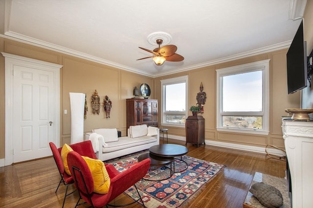 living room with ceiling fan, crown molding, and dark hardwood / wood-style floors