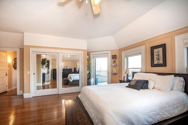 bedroom with vaulted ceiling, french doors, access to outside, dark wood-type flooring, and ceiling fan