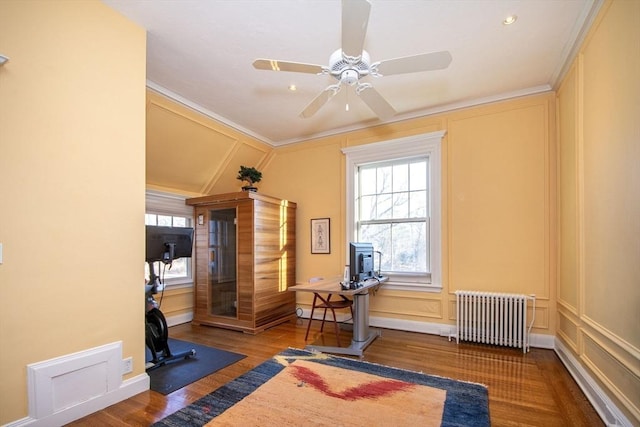 workout room with radiator heating unit, lofted ceiling, dark hardwood / wood-style floors, ornamental molding, and ceiling fan