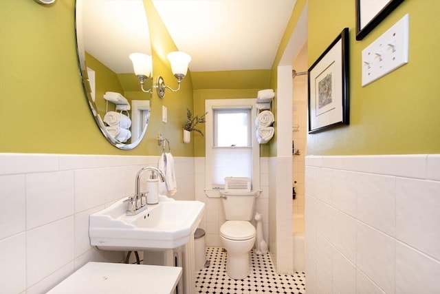 bathroom with tile patterned floors, sink, tile walls, and toilet