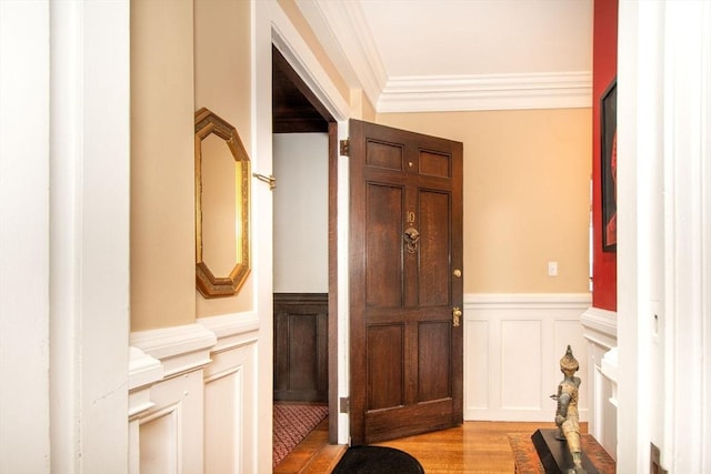 interior space featuring light wood-type flooring and crown molding