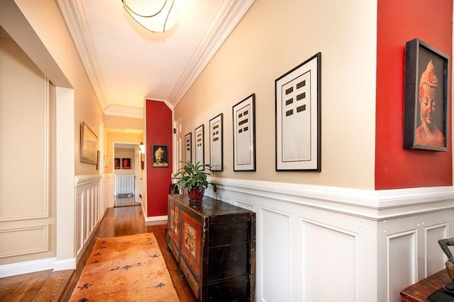 hall with hardwood / wood-style flooring and ornamental molding