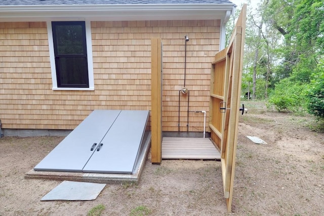 3 Gilbert Ln, Harwich, MA 02646 - exterior view of roof with shingles, a bulkhead entry, gutters, and a downspout