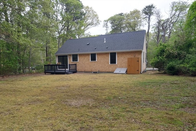 3 Gilbert Ln, Harwich, MA 02646 - back of property with a deck, a lawn, roof with shingles, and a chimney