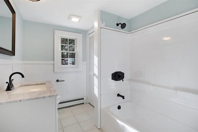 full bathroom featuring a baseboard heating unit, tile patterned floors, toilet, shower / tub combination, and vanity