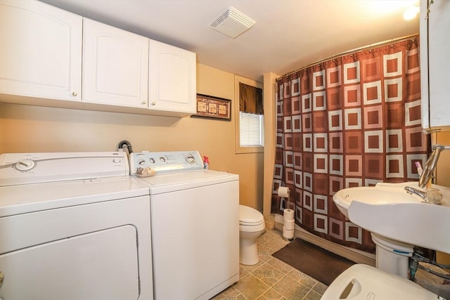 laundry room with laundry area, light tile patterned flooring, separate washer and dryer, and visible vents