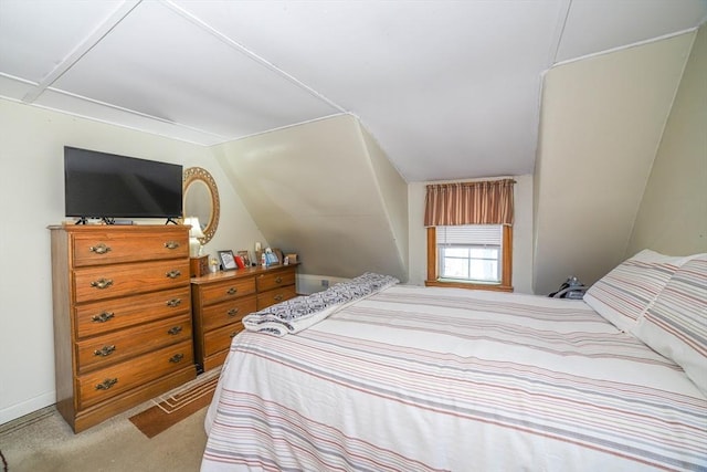 carpeted bedroom featuring vaulted ceiling