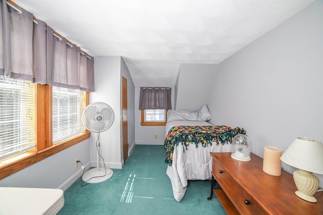 carpeted bedroom featuring baseboards and vaulted ceiling