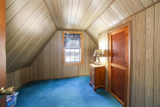 additional living space featuring carpet flooring, wood walls, and lofted ceiling