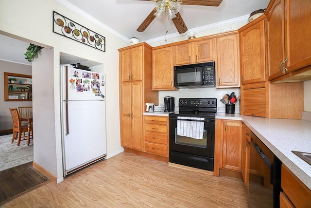 kitchen featuring black appliances, light wood finished floors, crown molding, and light countertops