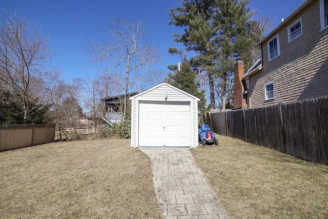 detached garage featuring fence