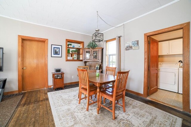 dining room with hardwood / wood-style floors, crown molding, and baseboards