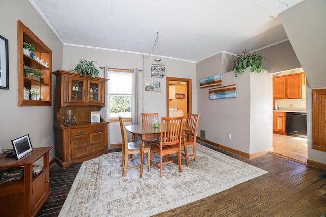 dining area with crown molding, dark wood-style floors, baseboards, and visible vents