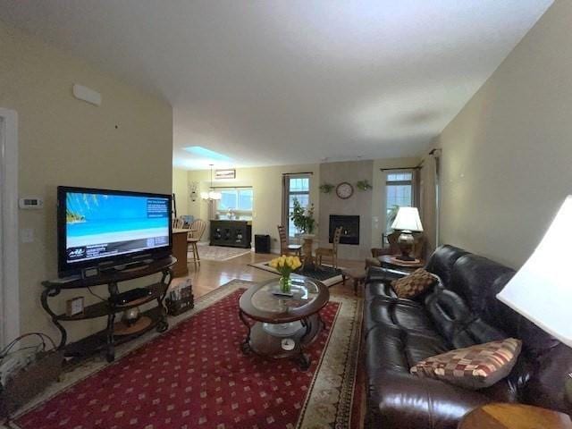 living room featuring hardwood / wood-style flooring and a large fireplace