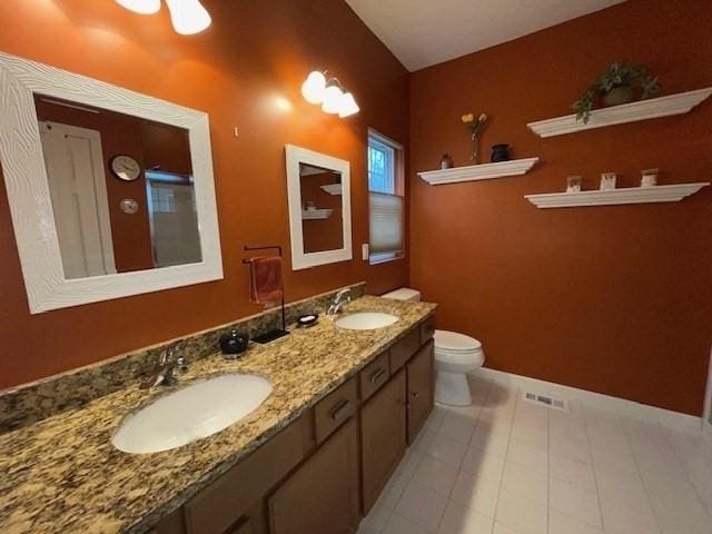 bathroom featuring tile patterned flooring, vanity, and toilet