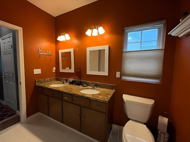 bathroom featuring tile patterned floors, vanity, and toilet