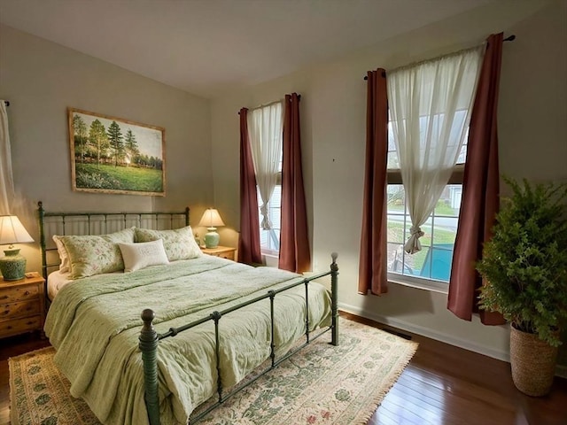 bedroom with dark hardwood / wood-style floors