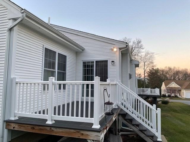 exterior space featuring a deck and a lawn