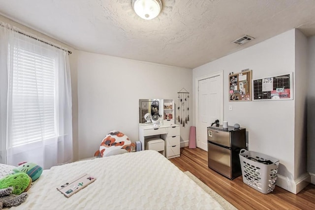 15 Ronan St Unit 3, Boston, MA 02125 - bedroom featuring wood finished floors, baseboards, and a textured ceiling