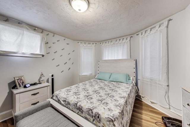 15 Ronan St Unit 3, Boston, MA 02125 - bedroom featuring wood finished floors, multiple windows, a textured ceiling, and baseboards