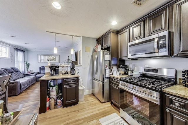 15 Ronan St Unit 3, Boston, MA 02125 - kitchen with appliances with stainless steel finishes, dark brown cabinetry, open floor plan, light wood-style floors, and decorative light fixtures