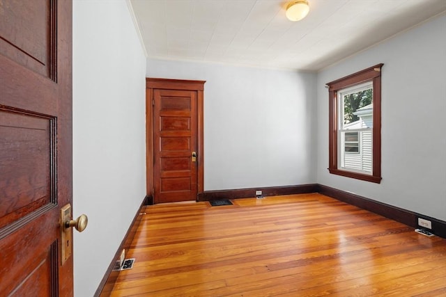 12 Leonard St, Somerville, MA 02144 - unfurnished room with light wood-style floors and crown molding