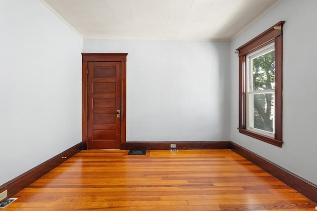 12 Leonard St, Somerville, MA 02144 - spare room with crown molding and light wood-style floors