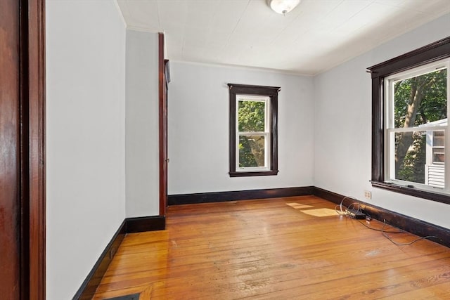 12 Leonard St, Somerville, MA 02144 - spare room featuring plenty of natural light, hardwood / wood-style floors, and ornamental molding