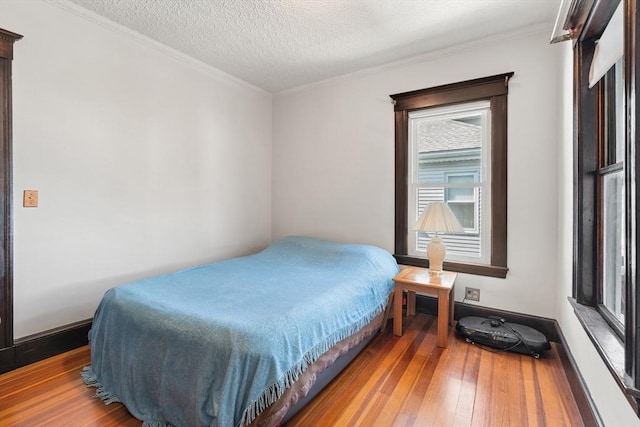 12 Leonard St, Somerville, MA 02144 - bedroom with wood-type flooring, crown molding, and a textured ceiling