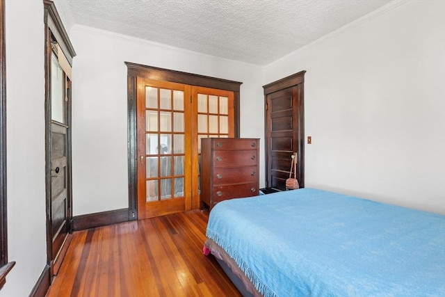 12 Leonard St, Somerville, MA 02144 - bedroom featuring hardwood / wood-style flooring, french doors, and a textured ceiling