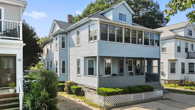 12 Leonard St, Somerville, MA 02144 - view of side of home with a sunroom and a chimney