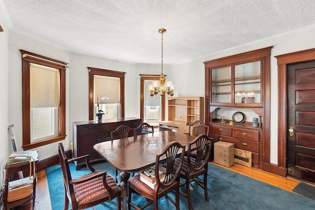 12 Leonard St, Somerville, MA 02144 - dining space featuring a chandelier, dark wood finished floors, and a textured ceiling