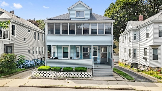 12 Leonard St, Somerville, MA 02144 - view of front of house with a porch, a sunroom, and a shingled roof