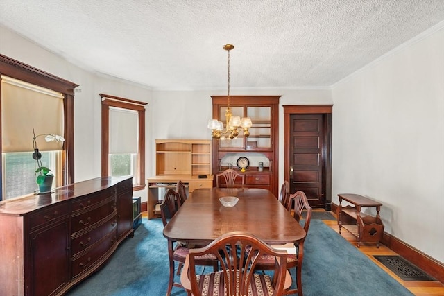 12 Leonard St, Somerville, MA 02144 - dining space with a chandelier, ornamental molding, and a textured ceiling