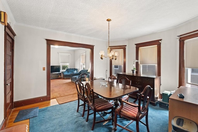 12 Leonard St, Somerville, MA 02144 - dining space with a chandelier, a textured ceiling, crown molding, and carpet flooring