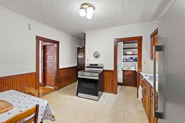 12 Leonard St, Somerville, MA 02144 - kitchen featuring electric stove, a wainscoted wall, a textured ceiling, ornamental molding, and wooden walls