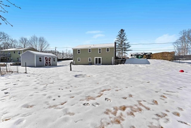 view of snow covered rear of property