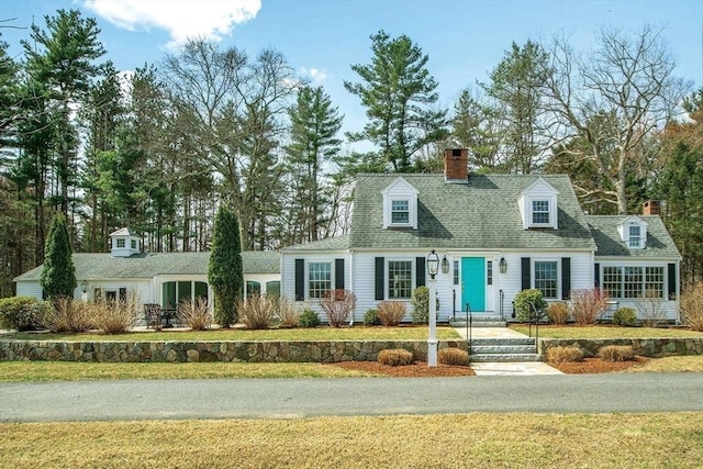 279 Norfolk St, Holliston, MA 01746 - new england style home featuring a chimney, a front lawn, and roof with shingles