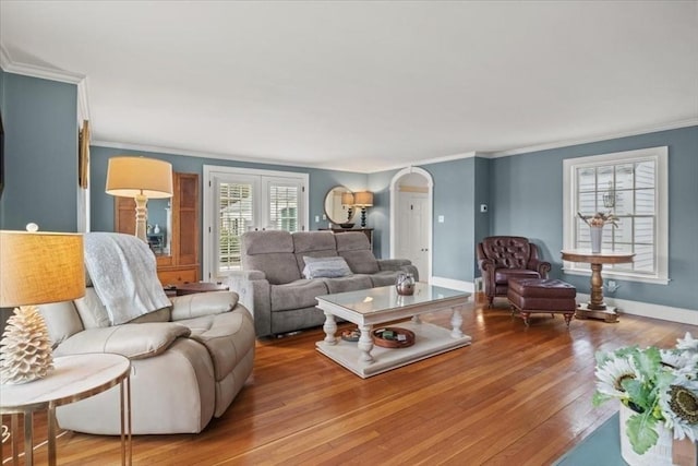 279 Norfolk St, Holliston, MA 01746 - living room featuring hardwood / wood-style flooring, crown molding, arched walkways, and french doors