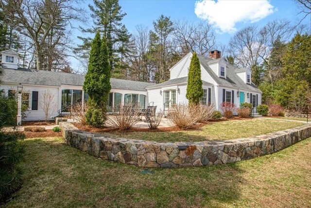 279 Norfolk St, Holliston, MA 01746 - rear view of house featuring a lawn, a patio, and a chimney